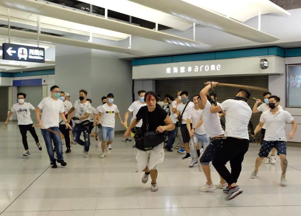 A group of gangsters in Yuen Long wearing white t-shirts on 21 July 2019 attacked passengers indifferently in the Yuen Long subway station in Hong Kong but police turned a blind eye and arrived after 39 minutes from people calling 999.
